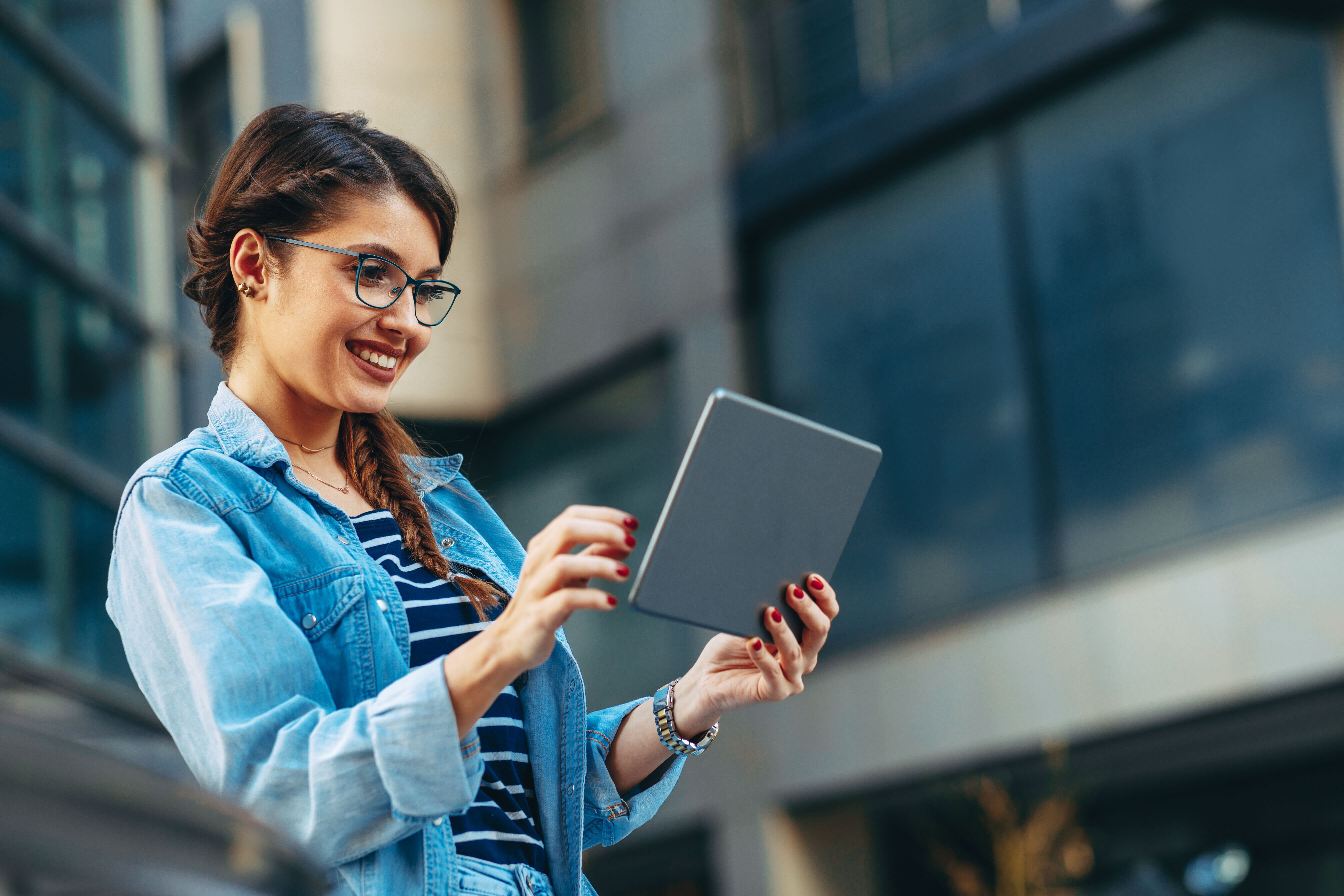 Young woman using a digital tablet reading about retail media