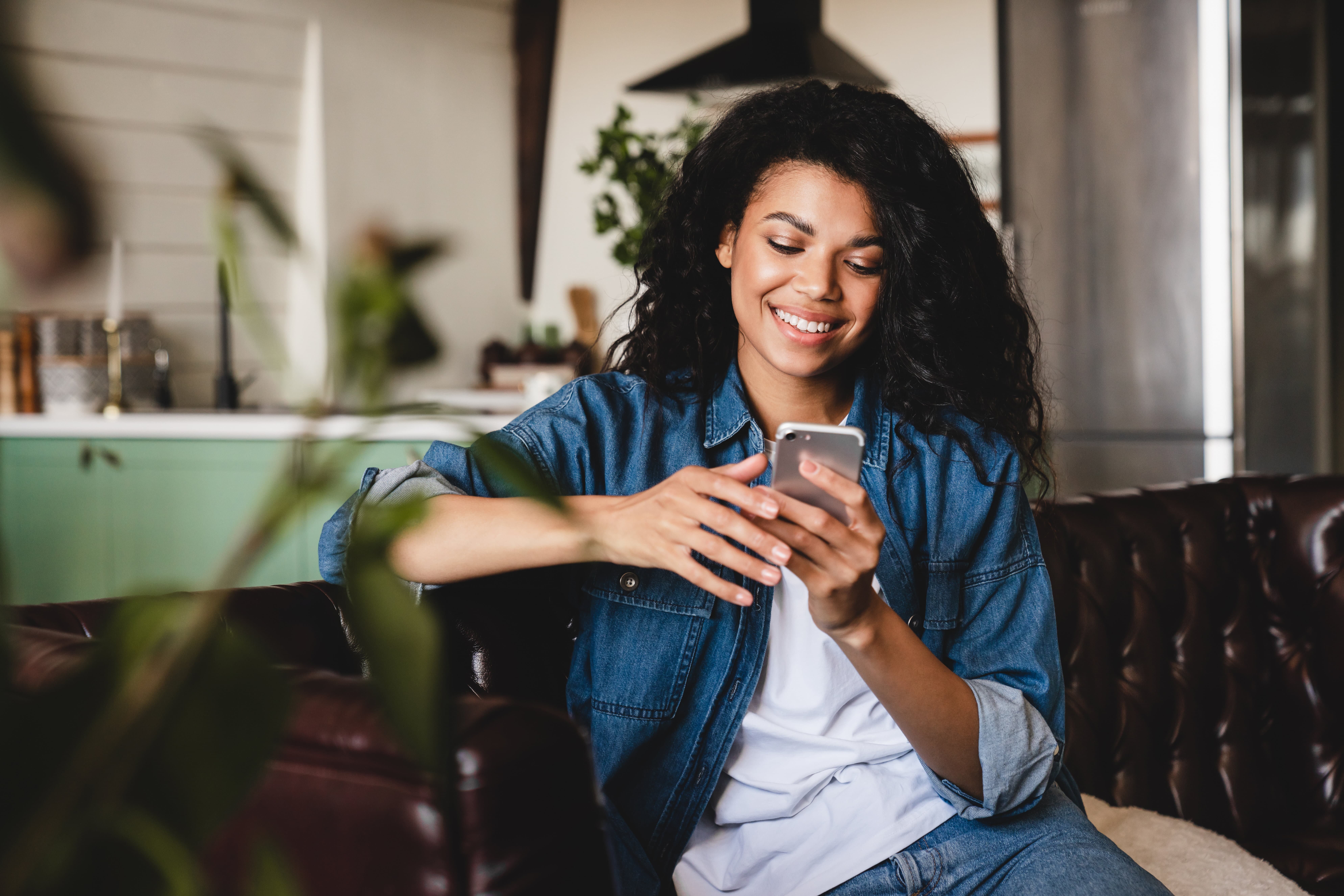 Smiling woman happily implementing retail media knowledge using smartphone