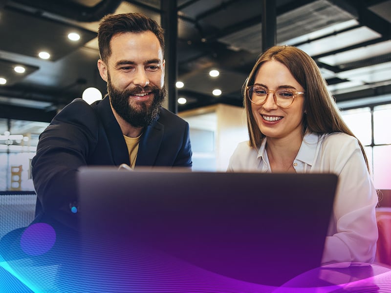 Businessman showing his colleague something on a laptop